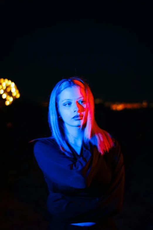 a woman with a neon light on in front of a camera