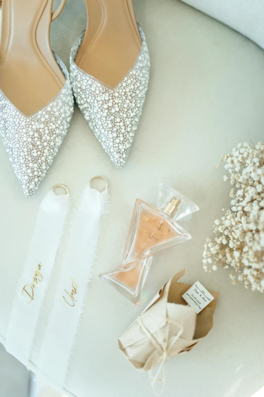 the shoes of an elegant bride sit on the table