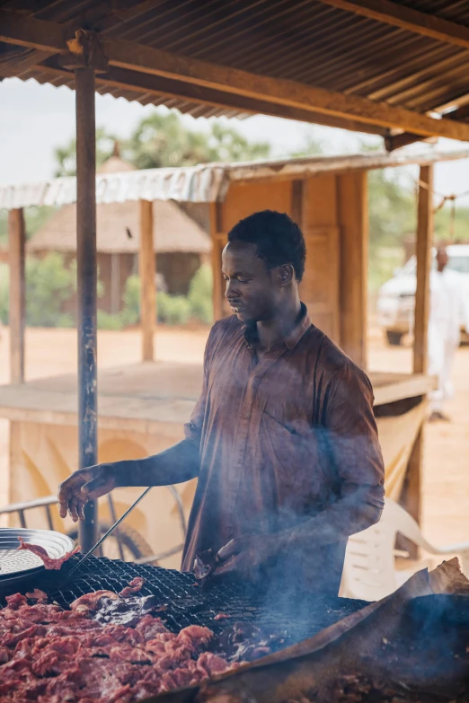 a man is cooking food on the grill