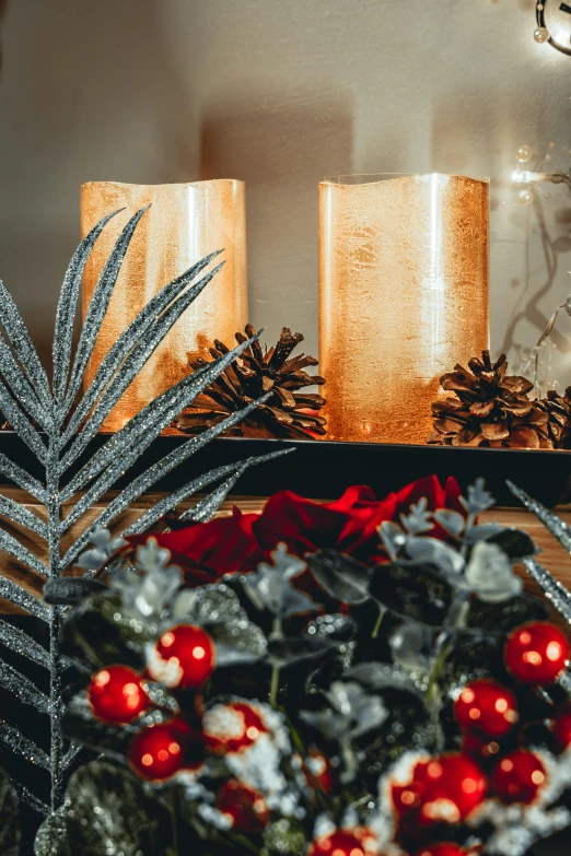 several silver candelabres on a table with holiday decorations