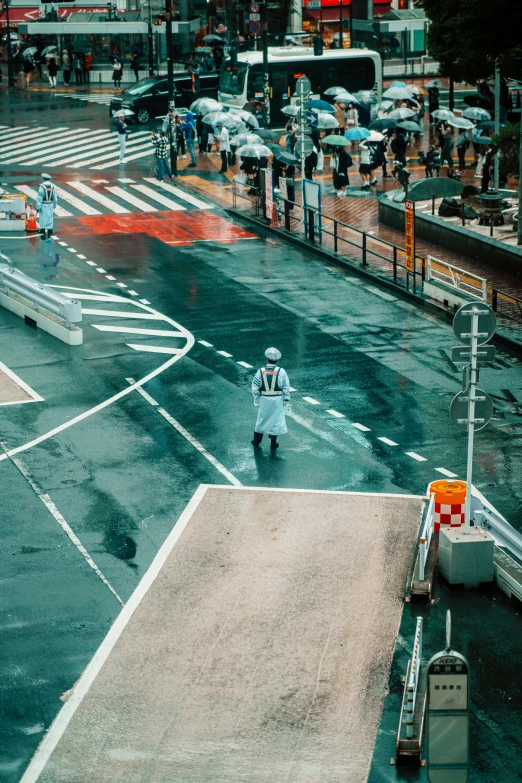 a person walking across an intersection wearing a body suit