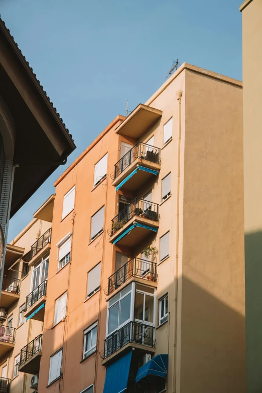 the corner of a building in front of an apartment block