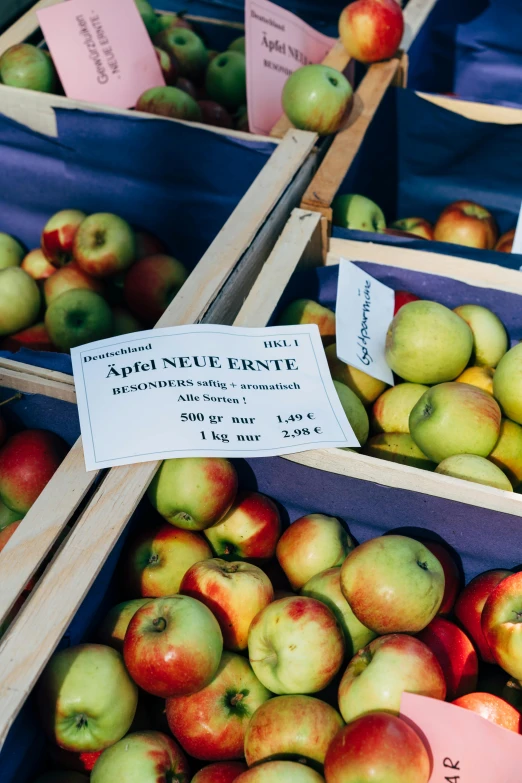 several crates of green and red apples