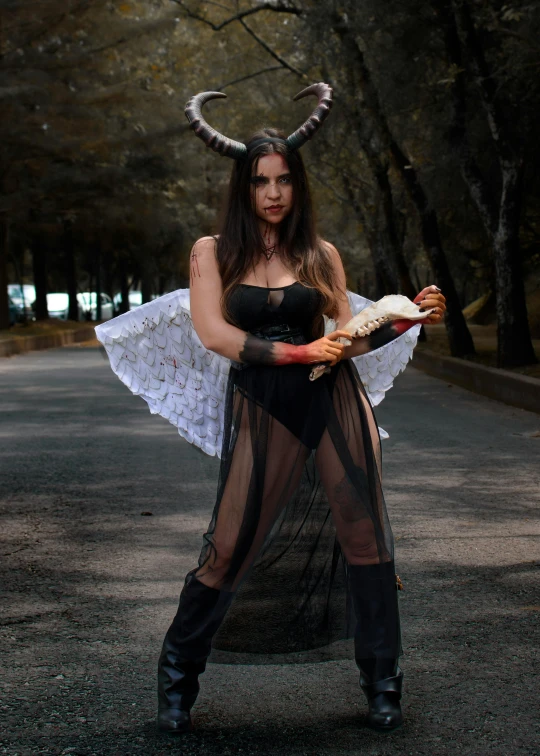 a woman with horns on her head, holding a plate