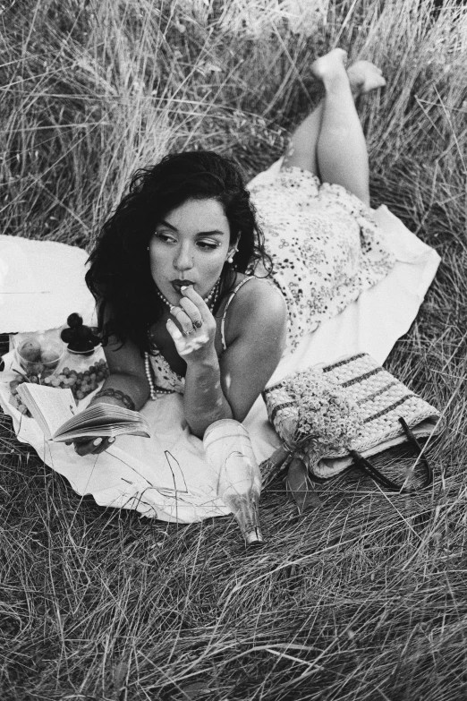 a girl laying on a blanket in the grass