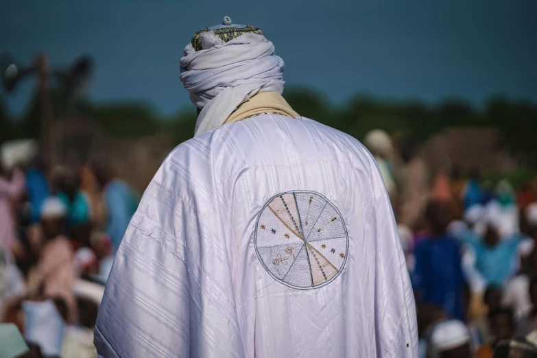 a man with a cross on his back and a shawl around his neck