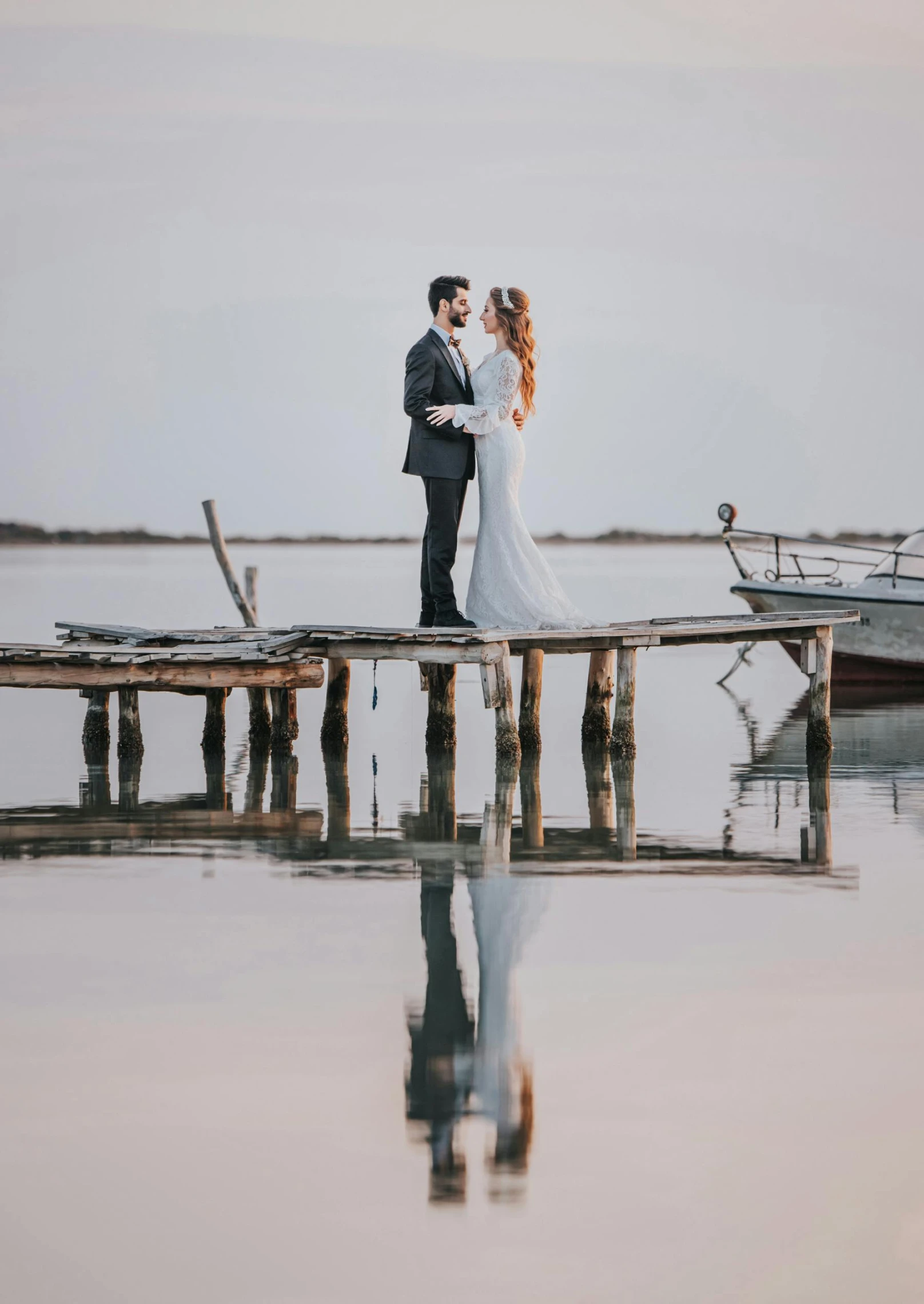 a newly married couple standing on a dock