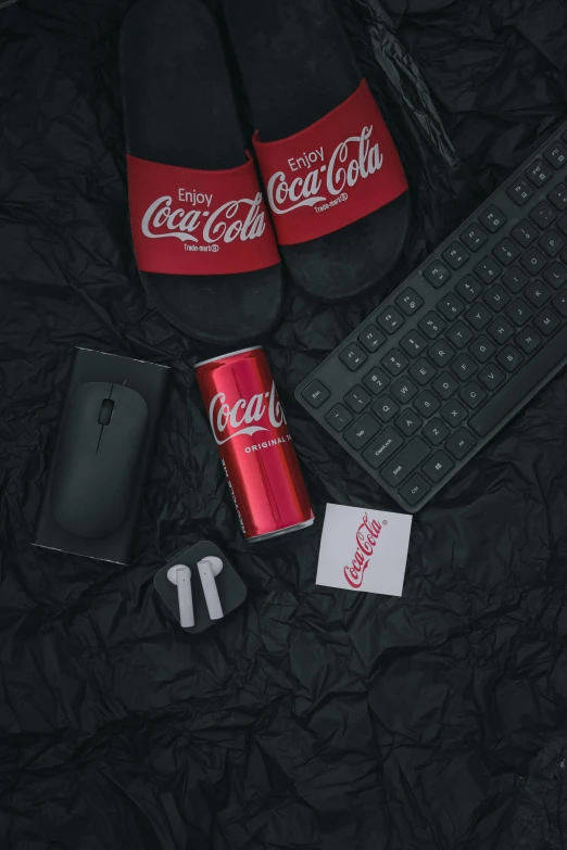 two coca colas are sitting next to a keyboard
