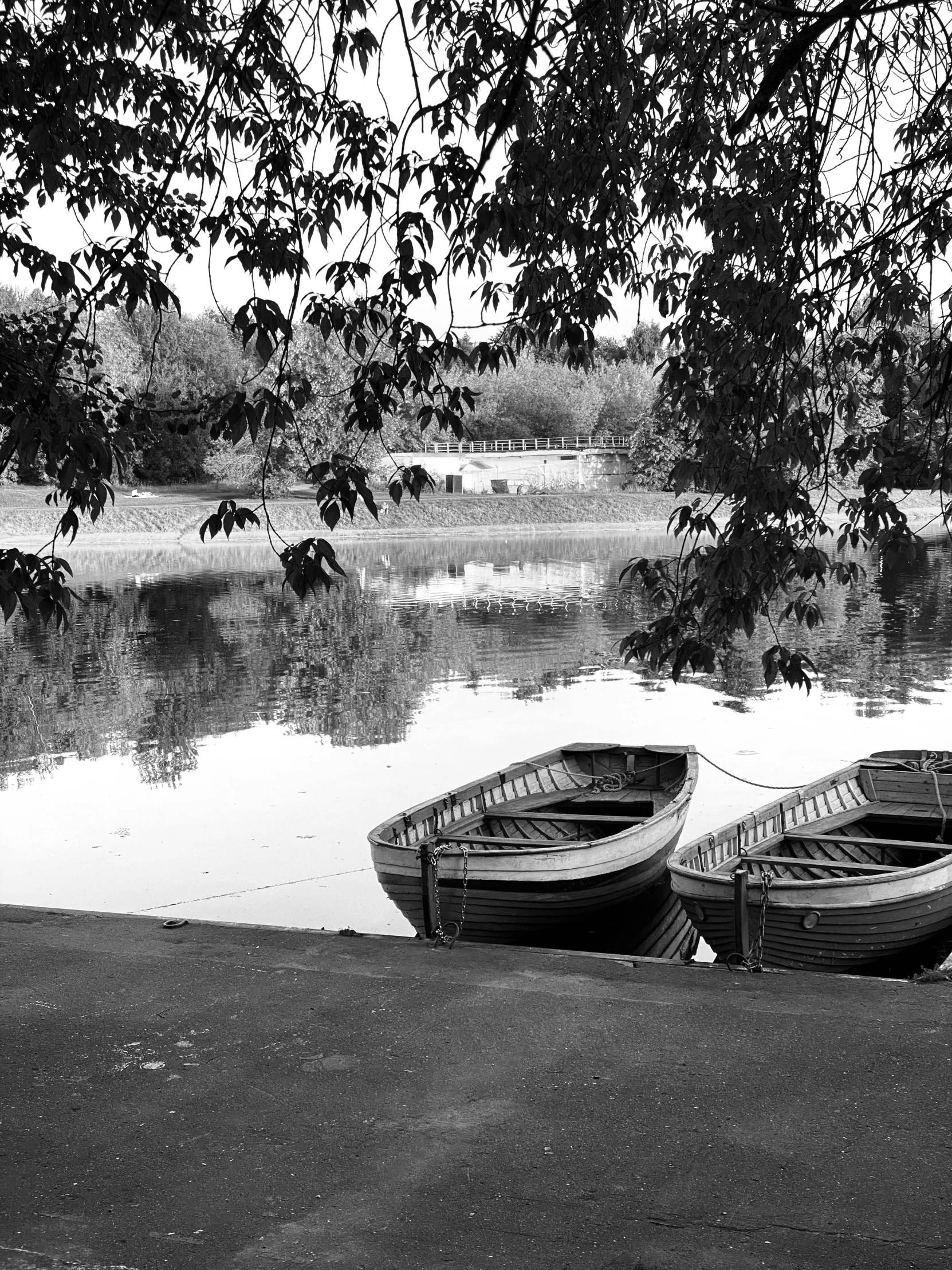 two small boats are docked in the shallow water