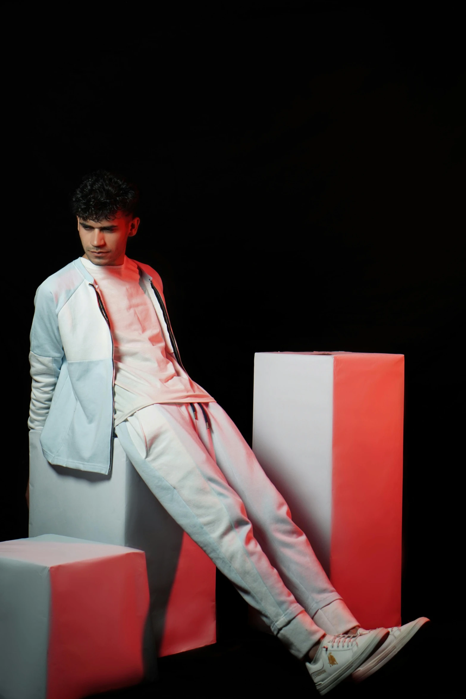 a man is posing by cubes in the dark