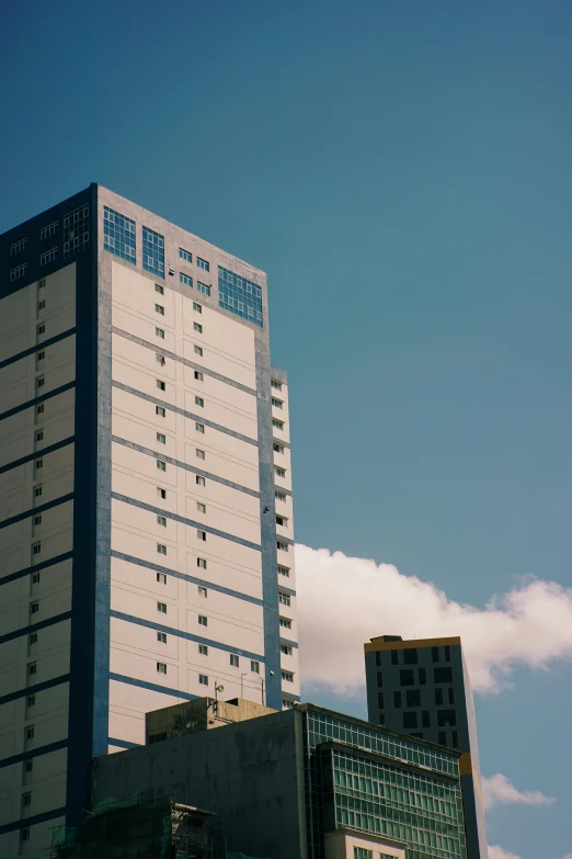 a very tall clock tower sitting in front of two buildings