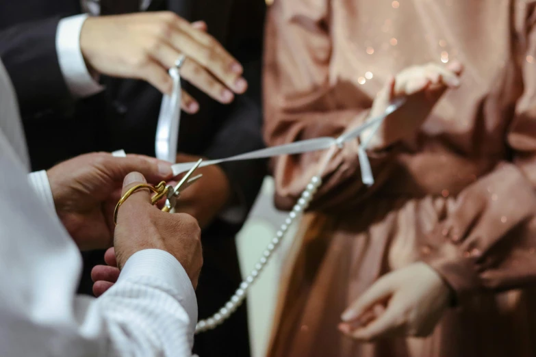 a couple  the ribbon to the bride and groom