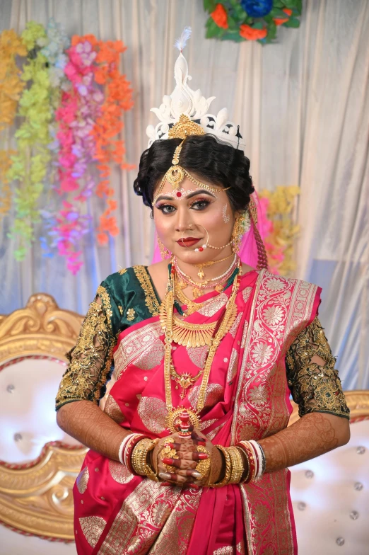 a woman wearing a tiara and standing in front of a stage