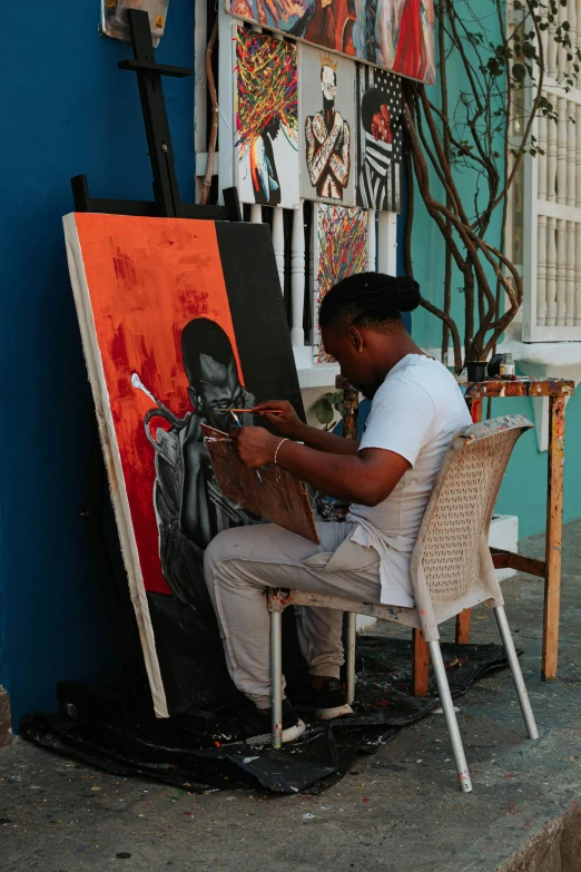 an art student is painting on the street