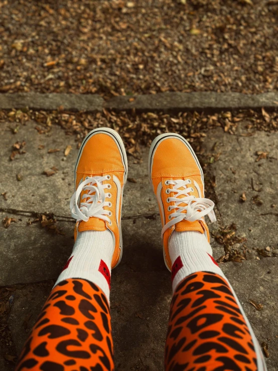 feet with orange and black animal print socks on