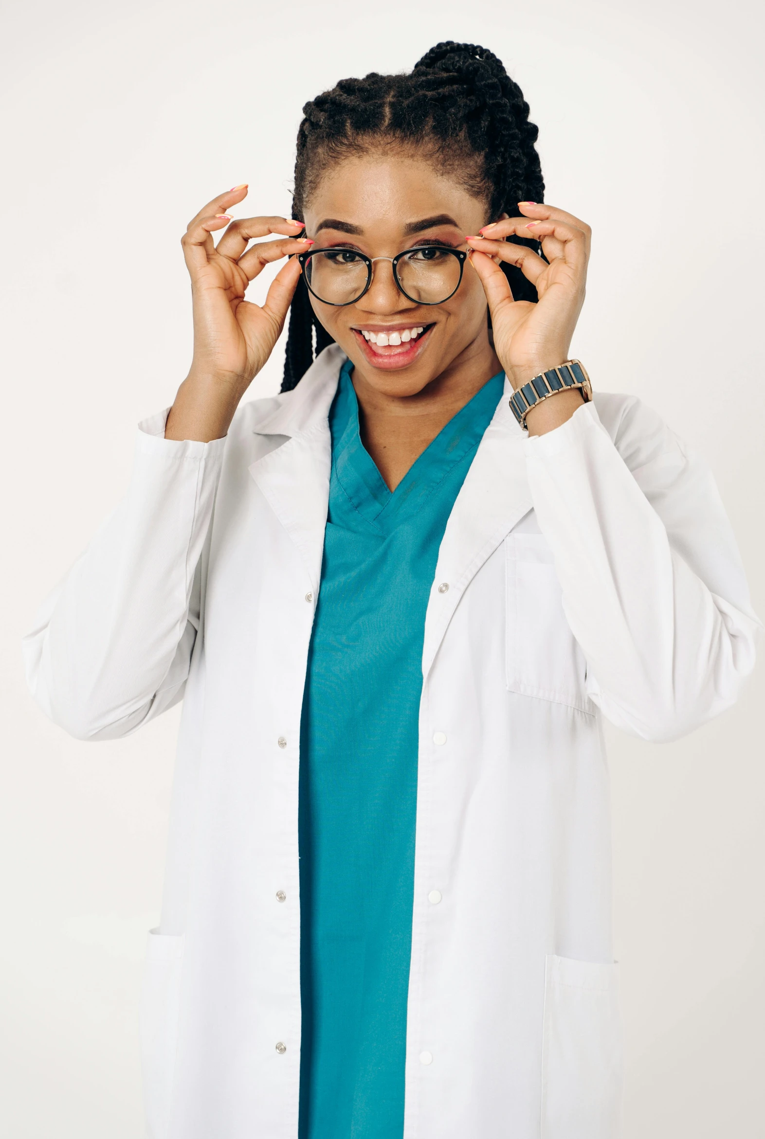 an african american woman wearing glasses in front of her white lab coat