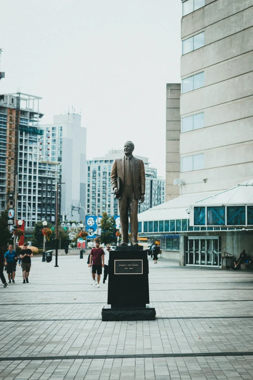 a statue of an individual is in the center of a square