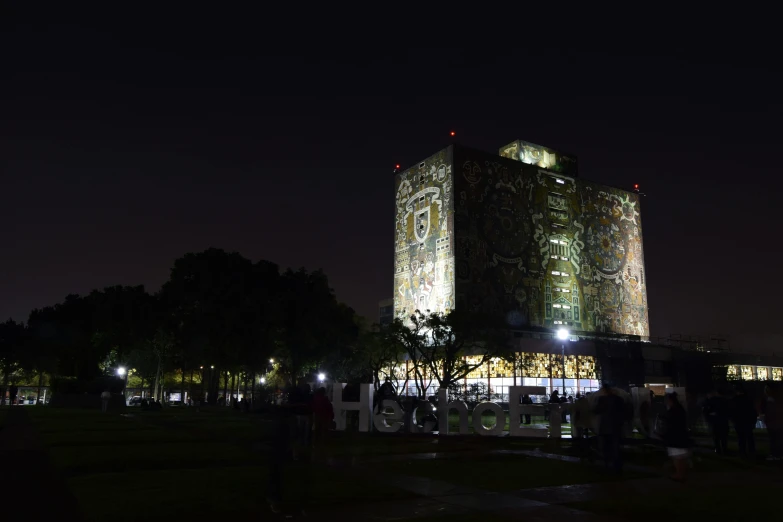 large building covered in decorative lights at night