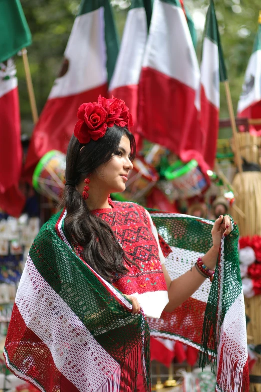 a woman is holding some scarves on the occasion of day