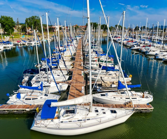 several white boats are in a marina during the day