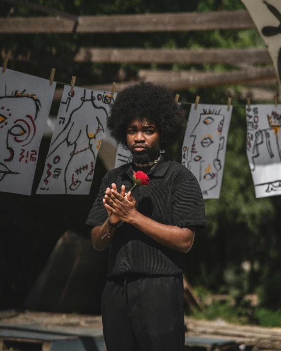 the woman is wearing all black and has flowers