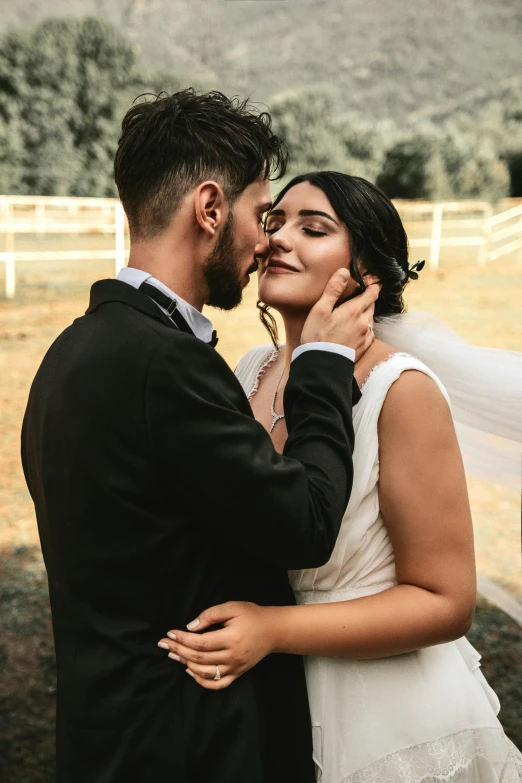 a bride and groom emcing each other outside