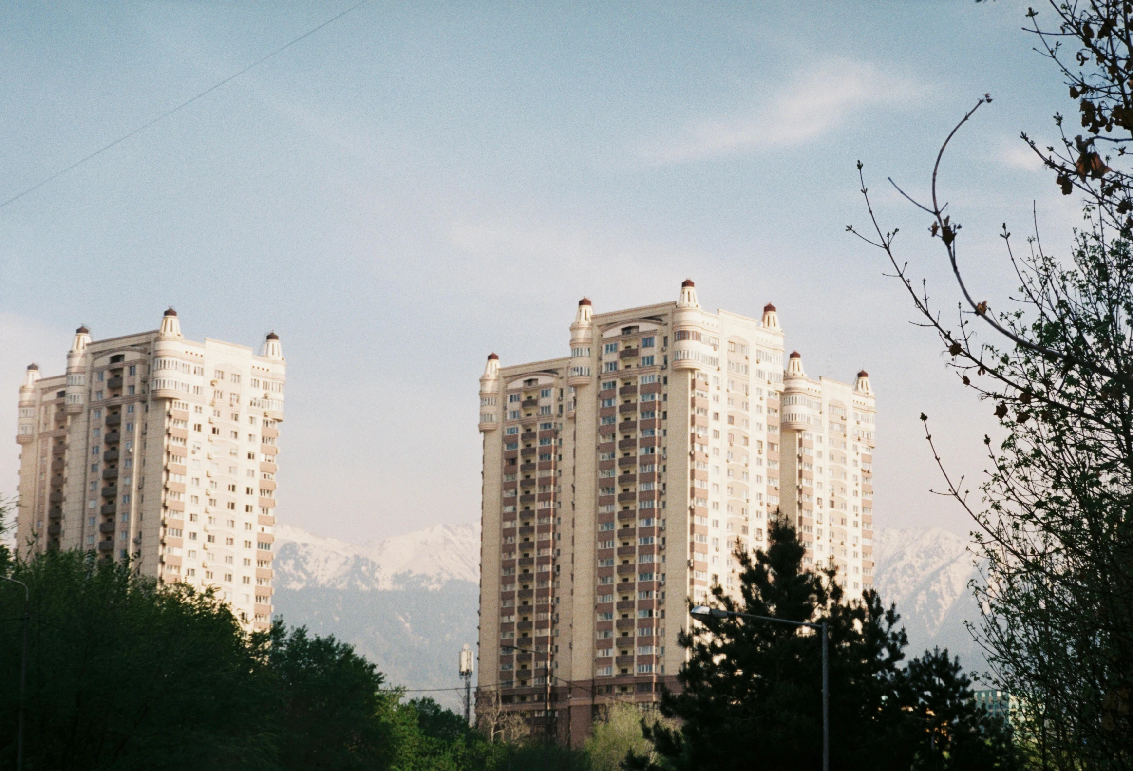 some very tall building in front of a hill