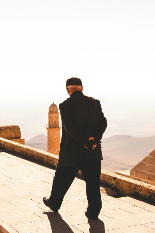 a man is standing near an old building