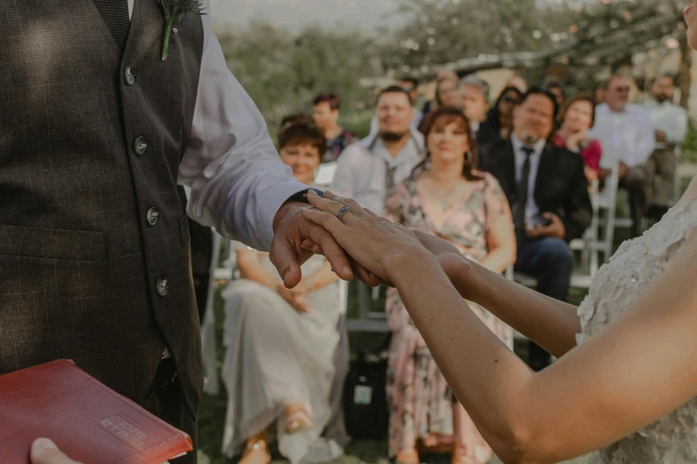 a bride and groom holding hands at their wedding