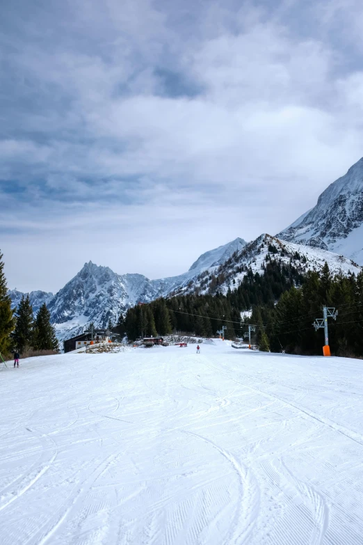 two people are skiing in the mountains covered in snow