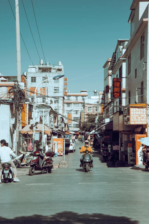 people riding motorcycles in a street with several signs