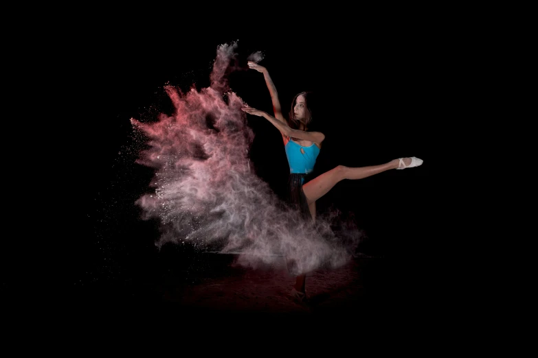 a woman posing for a picture next to pink and purple powder