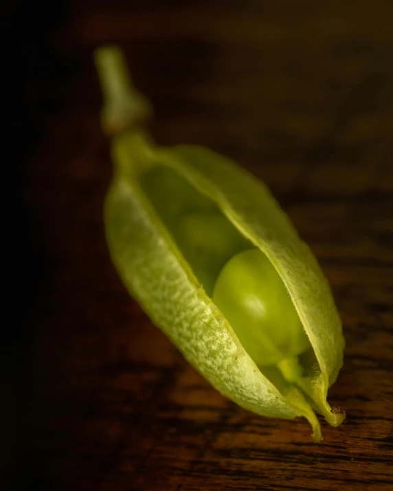 green pea pods on the side of a wooden table