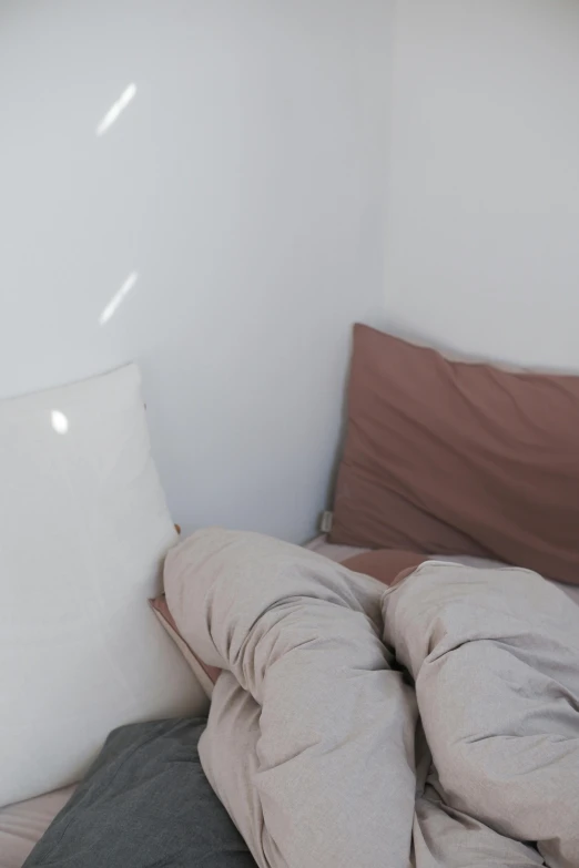 some pillows and pillows on a bed with a sheet