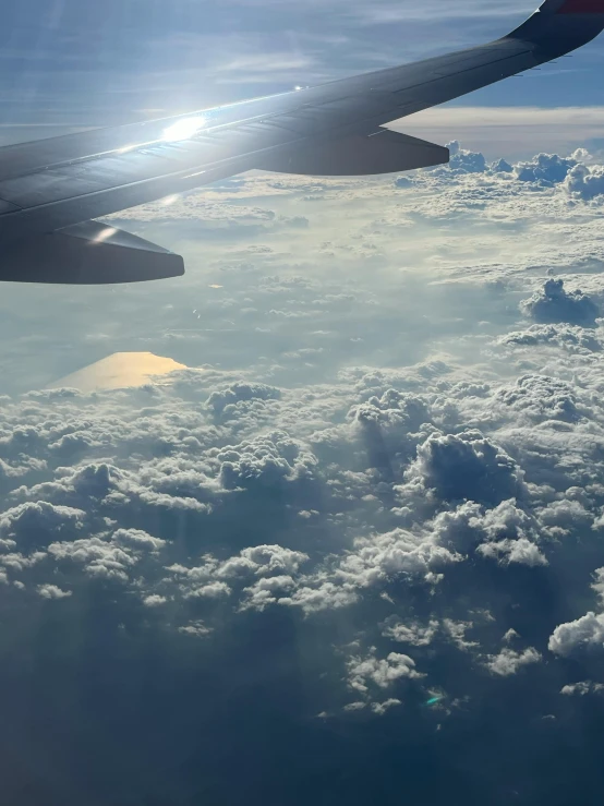 a wing of a jet flying through the sky