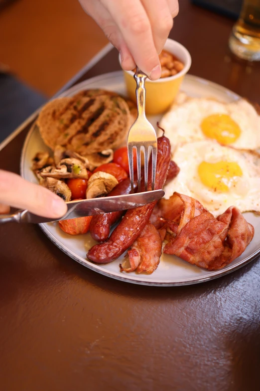 there is a person reaching for a fork with some food