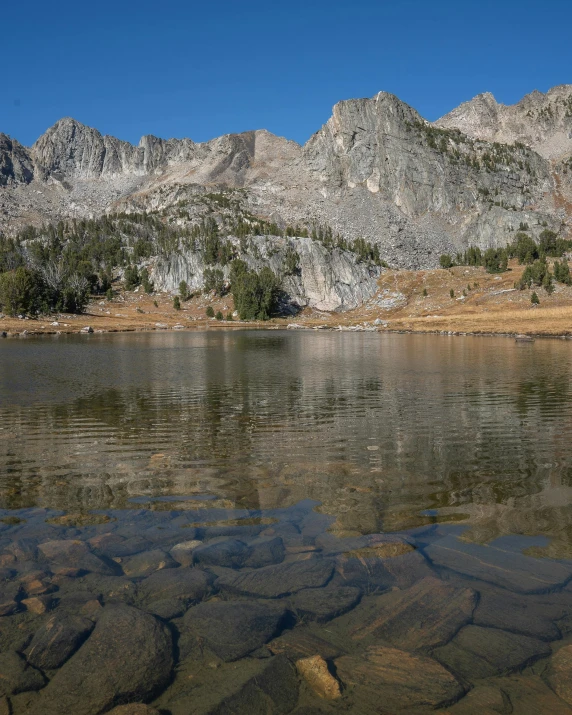 the mountains are reflected in the water and rock formations