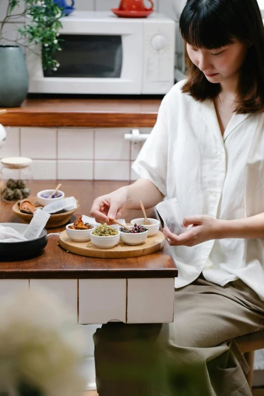 the woman is sitting down eating her meal