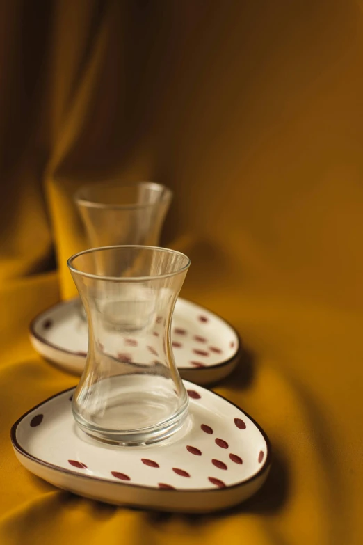 two matching dishes sitting on a table with a yellow background