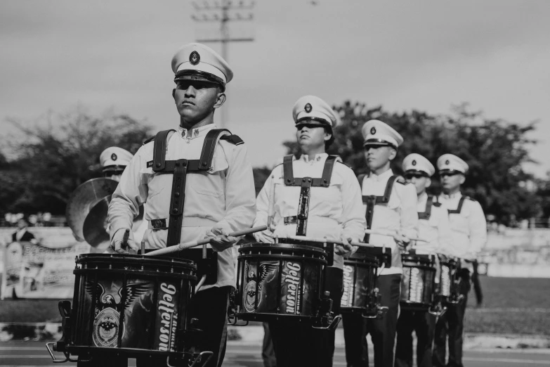 a group of drummers performing a musical performance with drum sticks