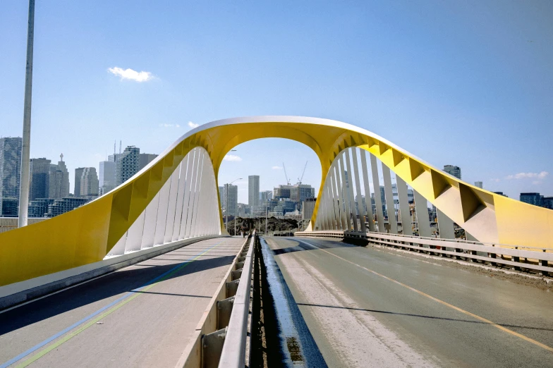 a very unique looking bridge with a train coming out