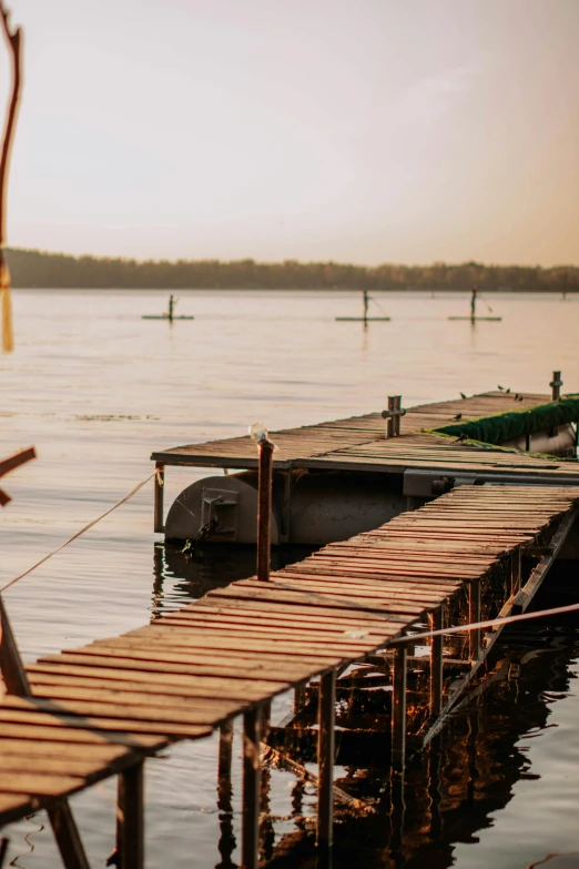 a wooden dock is surrounded by calm water