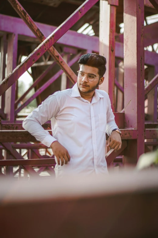 a man poses near a structure of construction