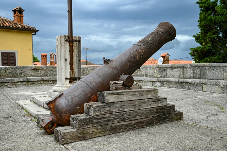 an old cannon laying on top of steps in a courtyard