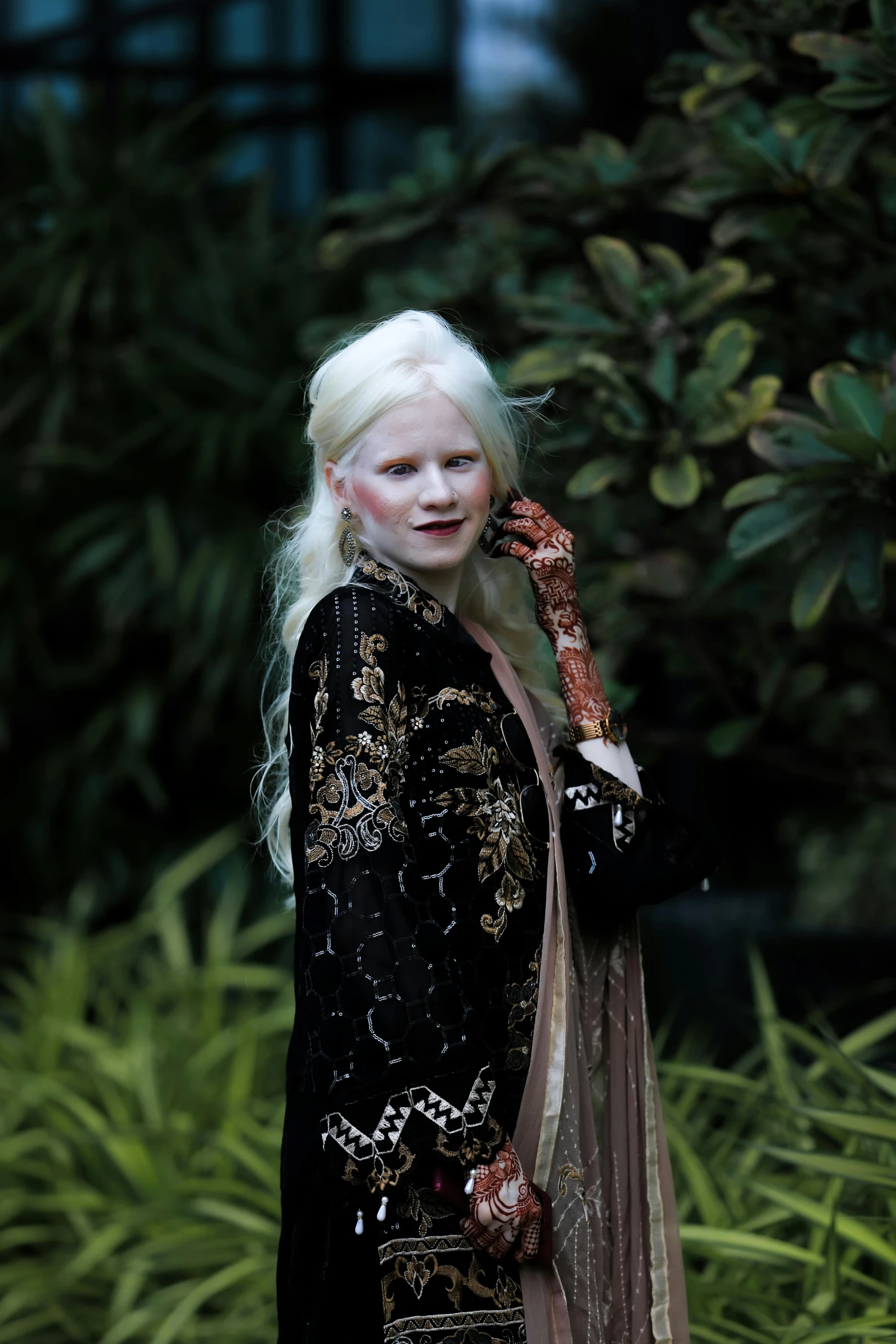 a woman in an elaborate dress talking on a phone