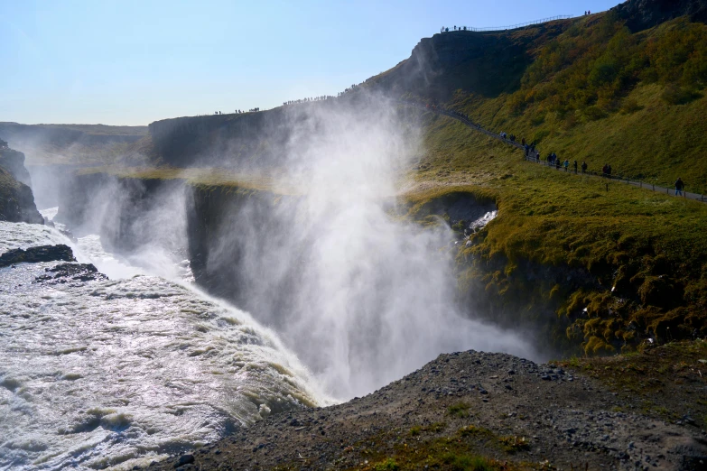 waterfall with water gushing from the side of it