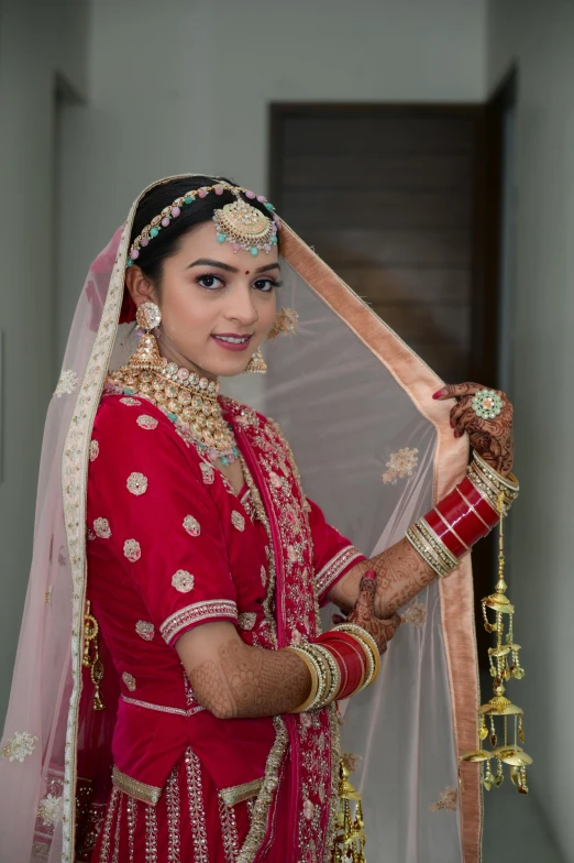 woman dressed in bright pink dress holding a veil