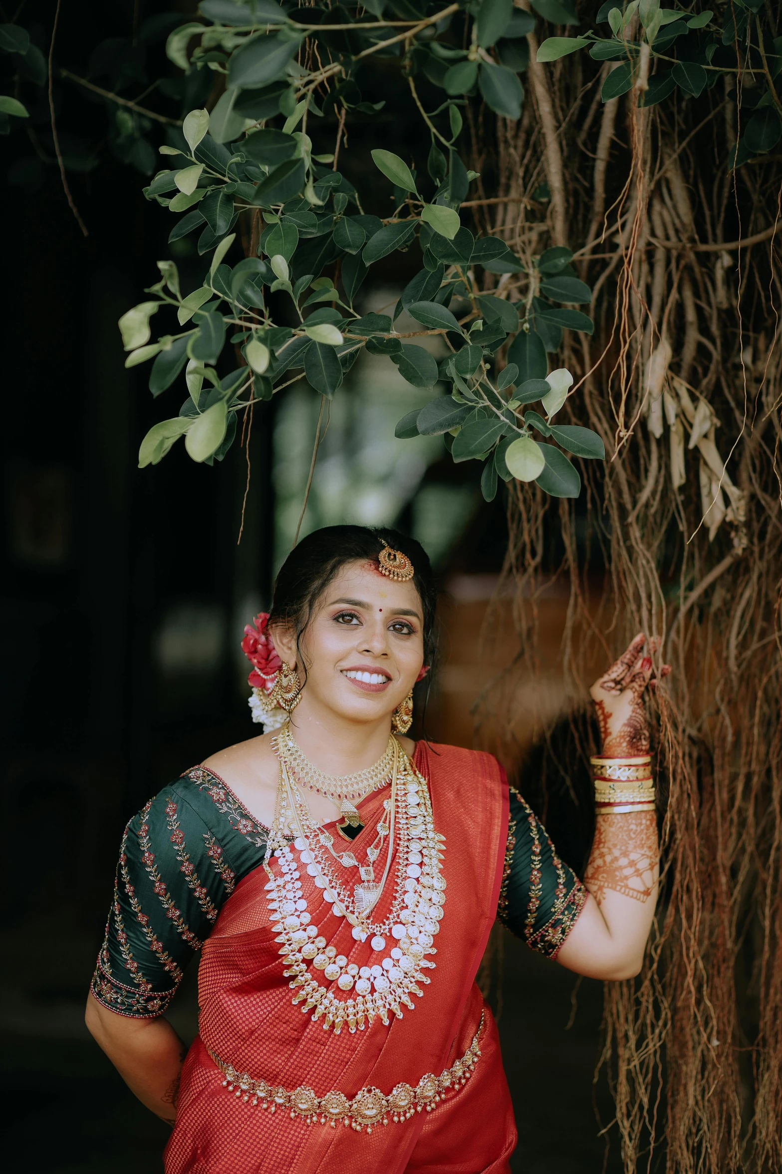 a woman dressed in a red, green and gold dress