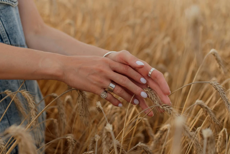 the person is holding on to the handle of the ring in the tall field