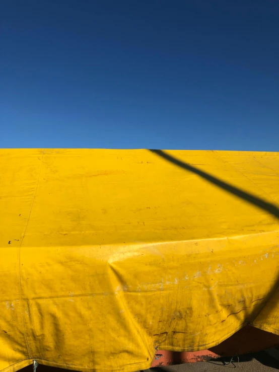 there is a boat covered in yellow tarps